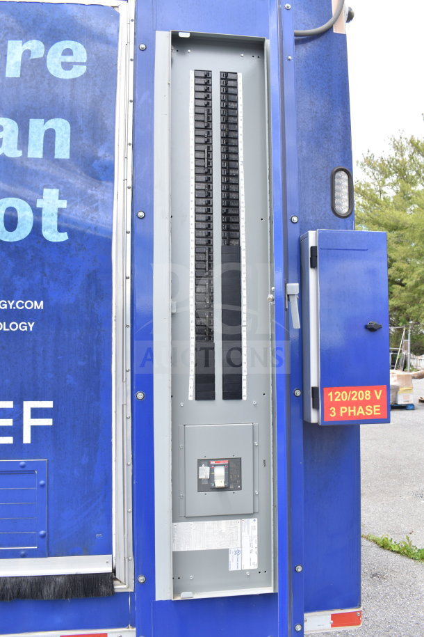 Rock Solid Cargo 28ft food trailer; 2021 model. Features CaptiveAire hood, refrigeration, Nieco charbroiler. Electrical panel, 120/208 V 3-phase visible.