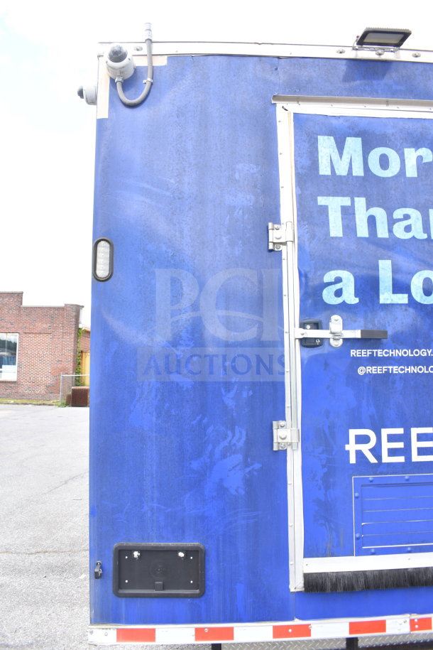 New 2021 Rock Solid Cargo 28ft food trailer, blue exterior, features CaptiveAire hood, refrigeration, Nieco charbroiler.