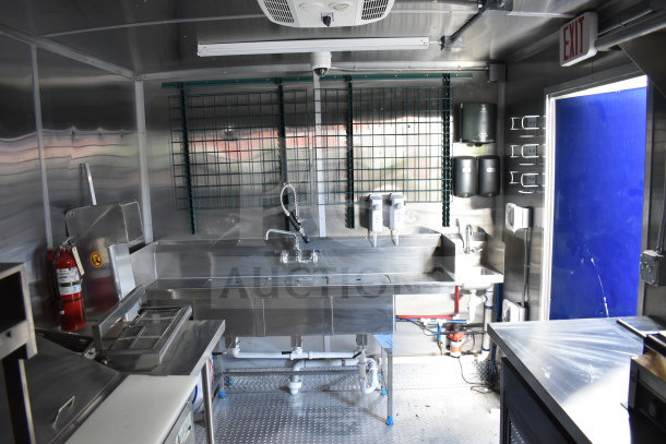 New 2021 Rock Solid Cargo 28ft food trailer interior with CaptiveAire hood, Nieco charbroiler, and complete refrigeration package.