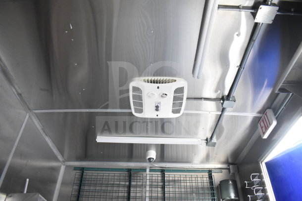 Interior of a 2021 Rock Solid Cargo 28ft food trailer, showing ceiling ventilation and lighting system. Visible exit sign.