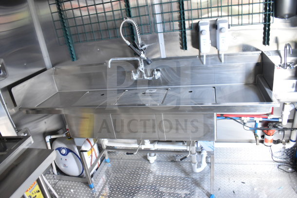 Stainless steel commercial kitchen sink in new 2021 Rock Solid Cargo 28ft food trailer. Features CaptiveAire hood, refrigeration package.