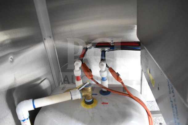 Interior view of 2021 Rock Solid Cargo food trailer showing plumbing connections with labeled red and blue valves.