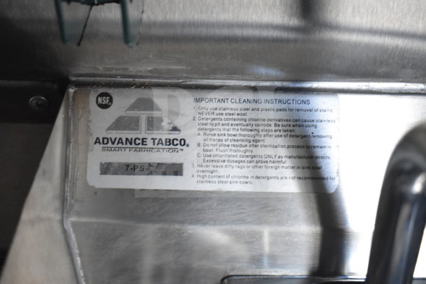 Advance Tabco cleaning instructions label on a stainless steel surface in a Rock Solid Cargo food trailer.