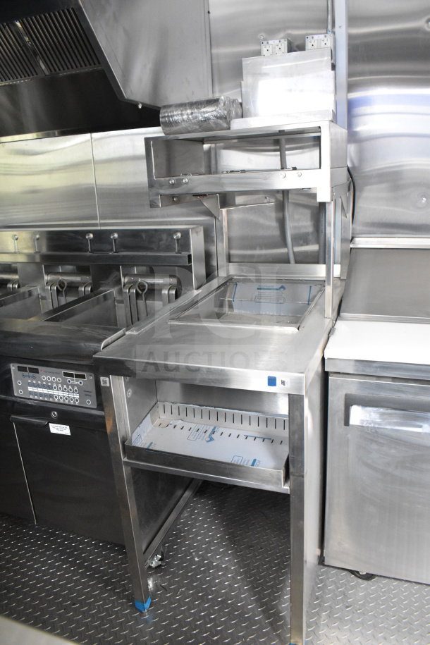 New 2021 Rock Solid Cargo 28ft food trailer interior, featuring CaptiveAire hood, refrigeration, and Nieco charbroiler.
