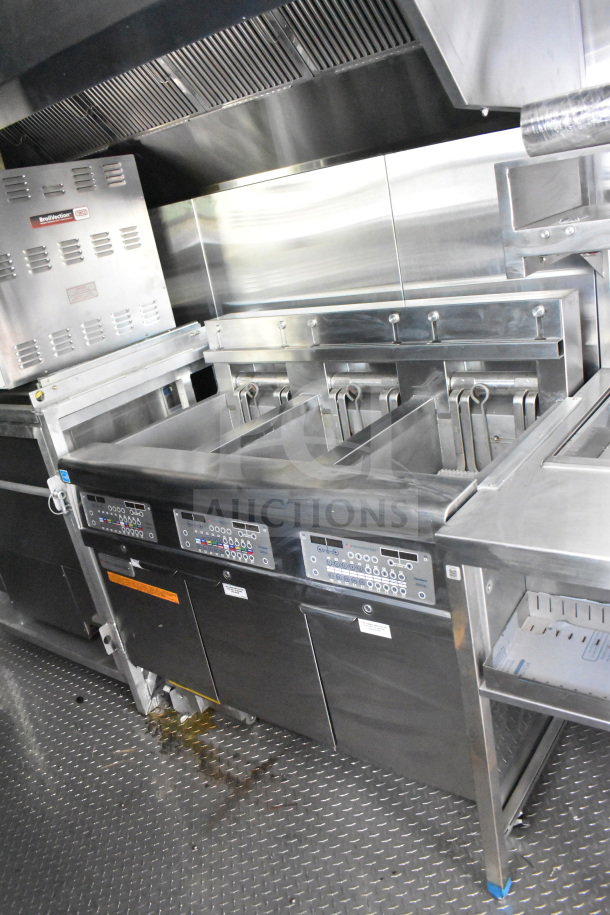 New 2021 Rock Solid Cargo 28ft food trailer interior with CaptiveAire hood, refrigeration, and Nieco Charbroiler.