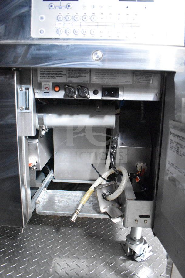 Inside view of a 2021 Rock Solid Cargo 28ft commercial food trailer, featuring stainless steel components and control panels.