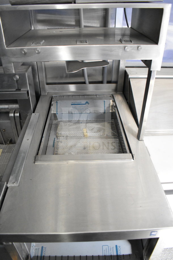 Rock Solid Cargo 28ft food trailer interior, features stainless steel surfaces, CaptiveAire hood, refrigeration package.