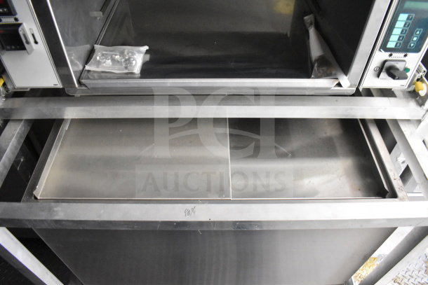 2021 Rock Solid Cargo 28ft food trailer interior, featuring CaptiveAire hood, refrigeration, and Nieco charbroiler. New condition.