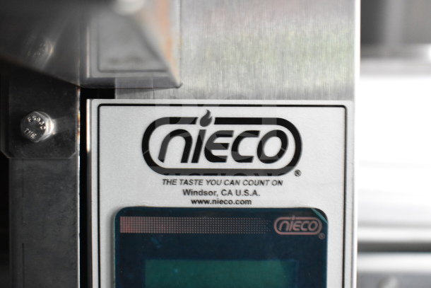 Nieco charbroiler label inside a 2021 Rock Solid Cargo 28ft commercial food trailer, featuring CaptiveAire hood and refrigeration system.