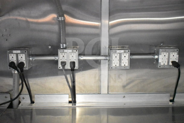 Power outlets inside 2021 Rock Solid Cargo 28ft food trailer. Features stainless steel walls, electrical wiring visible.