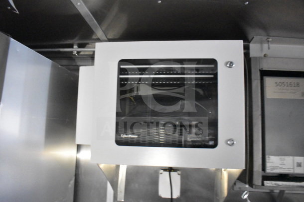 Rock Solid Cargo 28ft food trailer interior with a CaptiveAire hood, refrigeration system, and Nieco charbroiler setup.