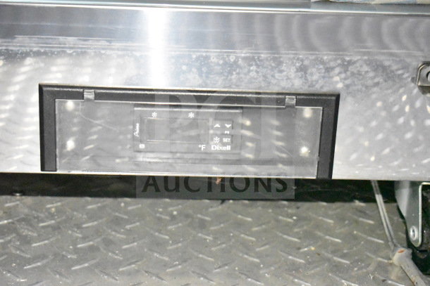 Control panel on a Dixell refrigeration unit in a Rock Solid Cargo 28ft commercial food trailer, showing settings and indicators.