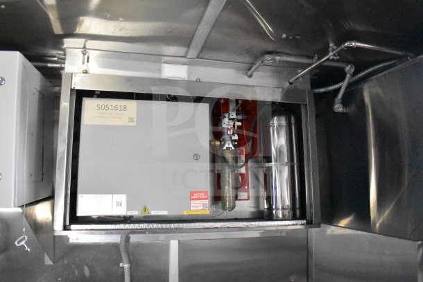 New 2021 Rock Solid Cargo food trailer interior showing CaptiveAire hood system and labels. VIN: 7H2BE2837ND041749.