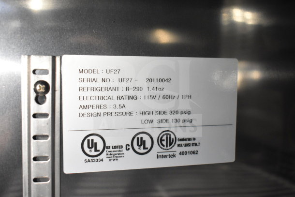 Label on commercial equipment showing model UF27, serial UF27-20110042, refrigerant R-290, and electrical specs.