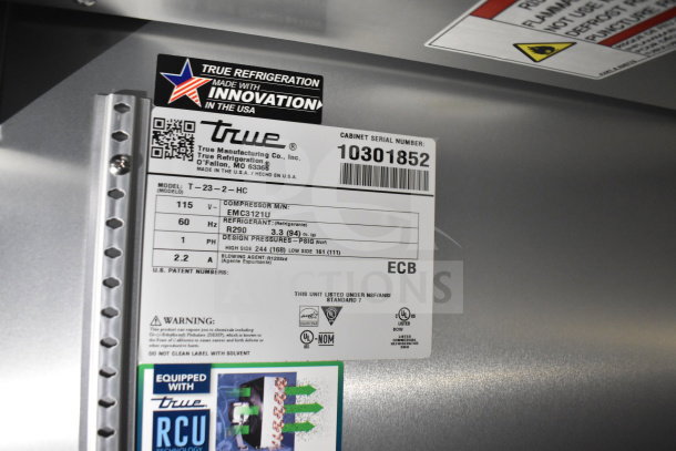 Label showing True Refrigeration specs: Model T-23-2-HC, serial number 10301852, EMC3121U compressor.