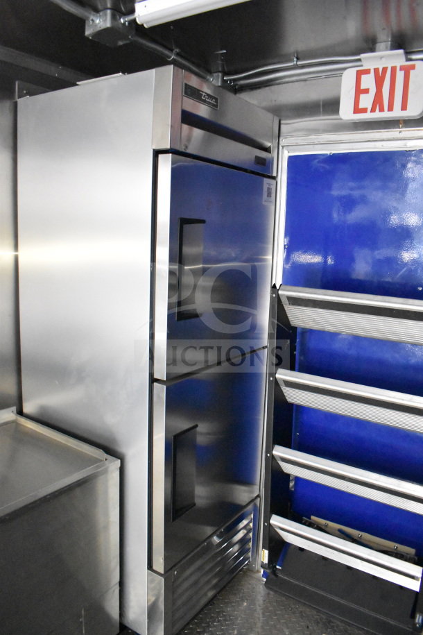 New 2021 Rock Solid Cargo 28ft food trailer interior, featuring a CaptiveAire hood, refrigeration system, and Nieco charbroiler.