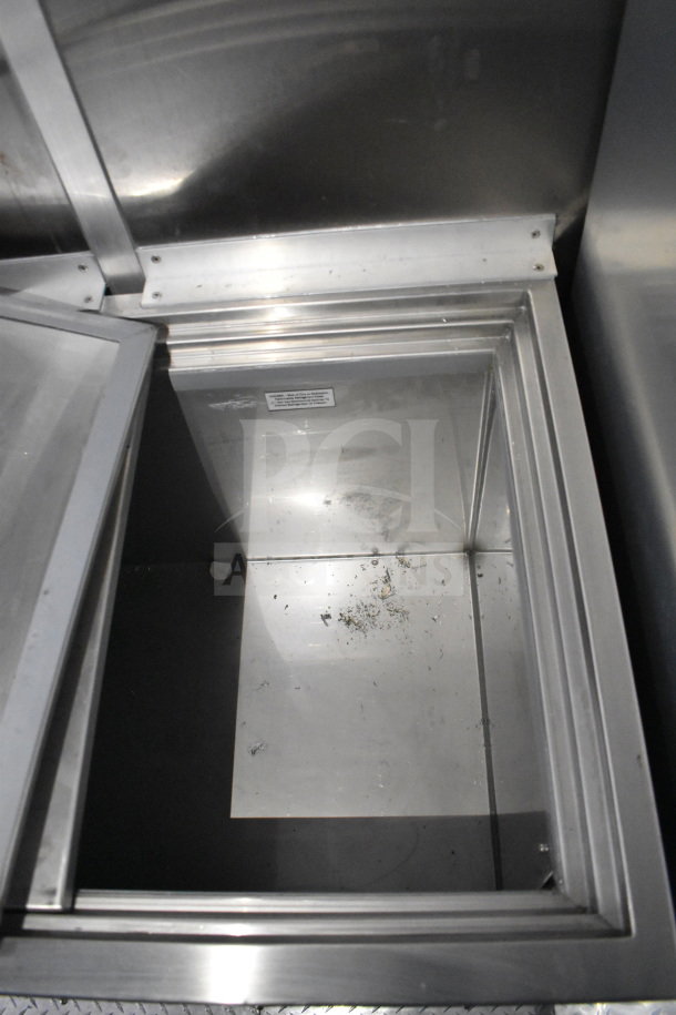 Open stainless steel compartment inside the 2021 Rock Solid Cargo 28ft commercial food trailer, showing interior space.