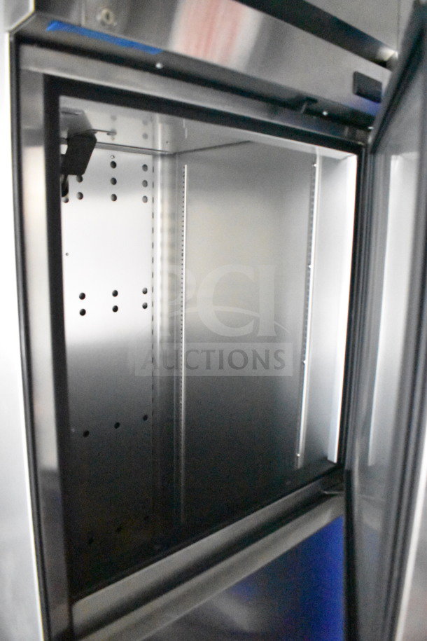 Interior view of new 2021 Rock Solid Cargo 28ft food trailer, featuring stainless steel refrigeration unit, spotless condition.