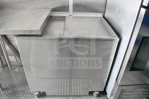 Rock Solid Cargo 28ft food trailer's stainless steel refrigeration unit. Features durable construction, built-in wheels.
