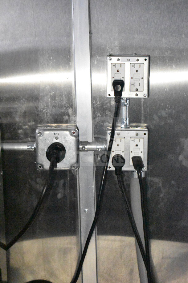 Electrical outlets and plugs inside a 2021 Rock Solid Cargo 28ft commercial food trailer, featuring a brushed metal interior.