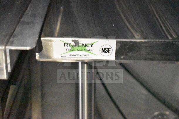 Stainless steel surface with Regency label showing NSF certification and model 600WT24X30SS in a food trailer.