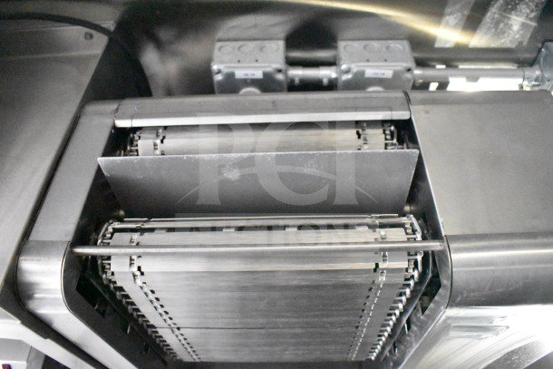 Rock Solid Cargo 28ft food trailer interior, showcasing a Nieco Charbroiler with stainless steel finish and conveyor belt system.