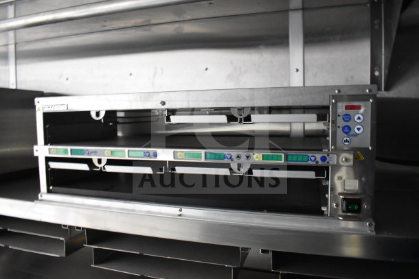 New 2021 Rock Solid Cargo 28ft food trailer interior showing CaptiveAire hood system; features stainless steel construction.