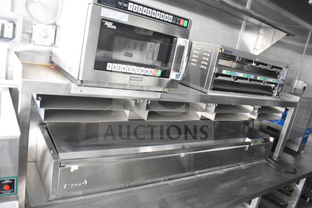 Commercial kitchen equipment inside new 2021 Rock Solid Cargo 28ft food trailer, featuring Sharp microwave and Nieco charbroiler.