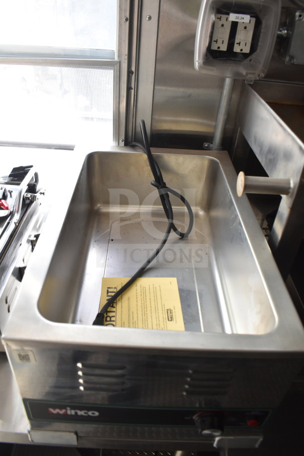 New 2021 Rock Solid Cargo food trailer interior showing Winco pan, power outlet, and instructional label.