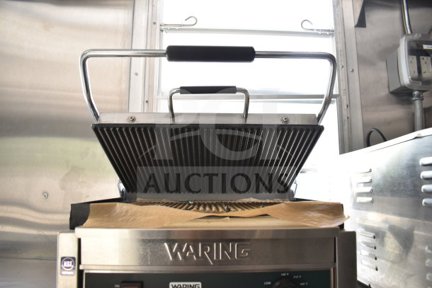 Waring commercial panini press inside a 2021 Rock Solid Cargo food trailer. Features ribbed plates and a stainless steel body.
