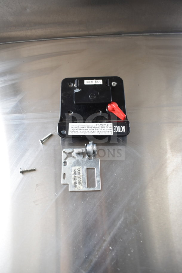 Close-up of a lock mechanism with screws and a metal bracket for a Rock Solid Cargo commercial food trailer.