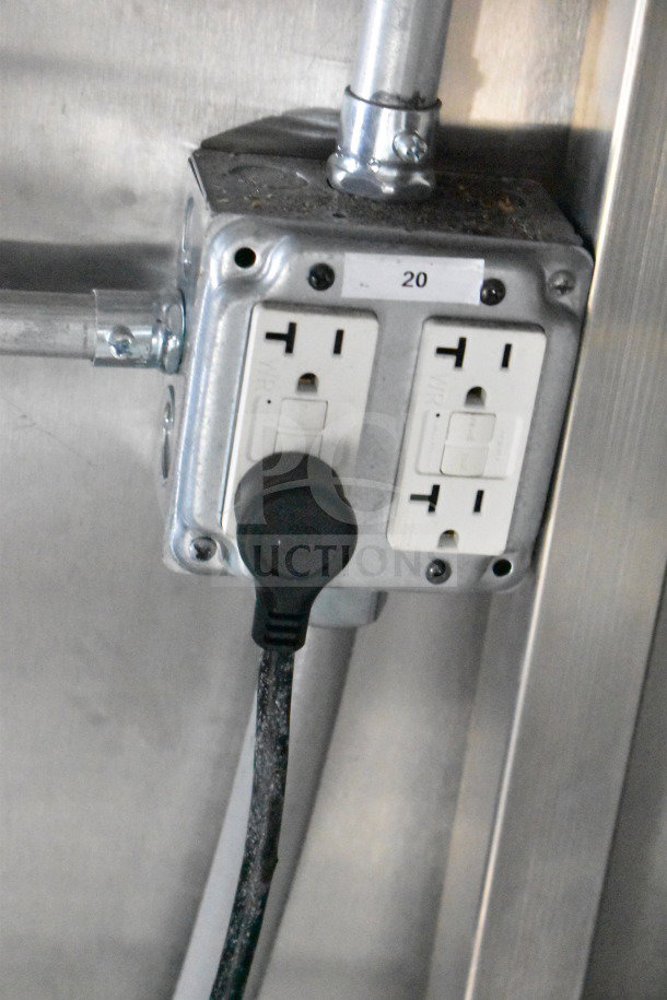 Electrical outlet with dual sockets inside a 2021 Rock Solid Cargo 28ft food trailer. Visible label reads "20."