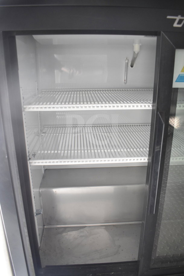 Interior view of the refrigeration unit in the 2021 Rock Solid Cargo 28ft food trailer, showing empty wire shelves.