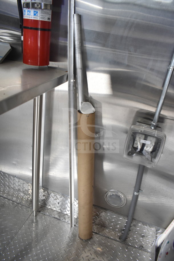 Interior of Rock Solid Cargo 28ft food trailer showing stainless steel fittings and a fire extinguisher.