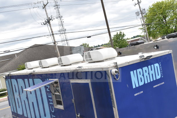Blue 2021 Rock Solid Cargo 28ft food trailer with rooftop cooling units and branding. Equipped with commercial kitchen setup.