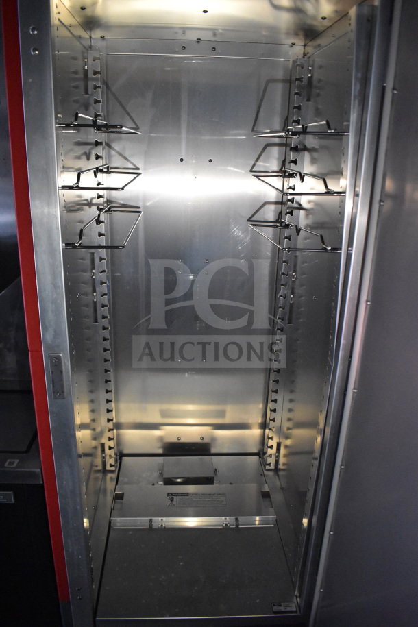 Interior of 2021 Rock Solid Cargo 28ft food trailer, stainless steel shelving, suitable for commercial use.