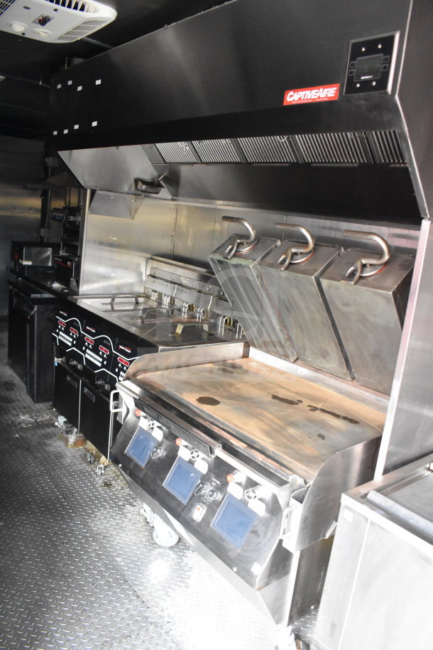 2021 Rock Solid Cargo 28ft food trailer with Henny Penny fryer, Taylor griddle, and CaptiveAire hood. Robust, fully equipped kitchen.