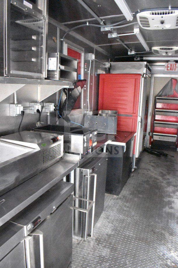 2021 Rock Solid Cargo 28ft food trailer interior featuring Henny Penny fryer, Taylor griddle, CaptiveAire hood, refrigerators.