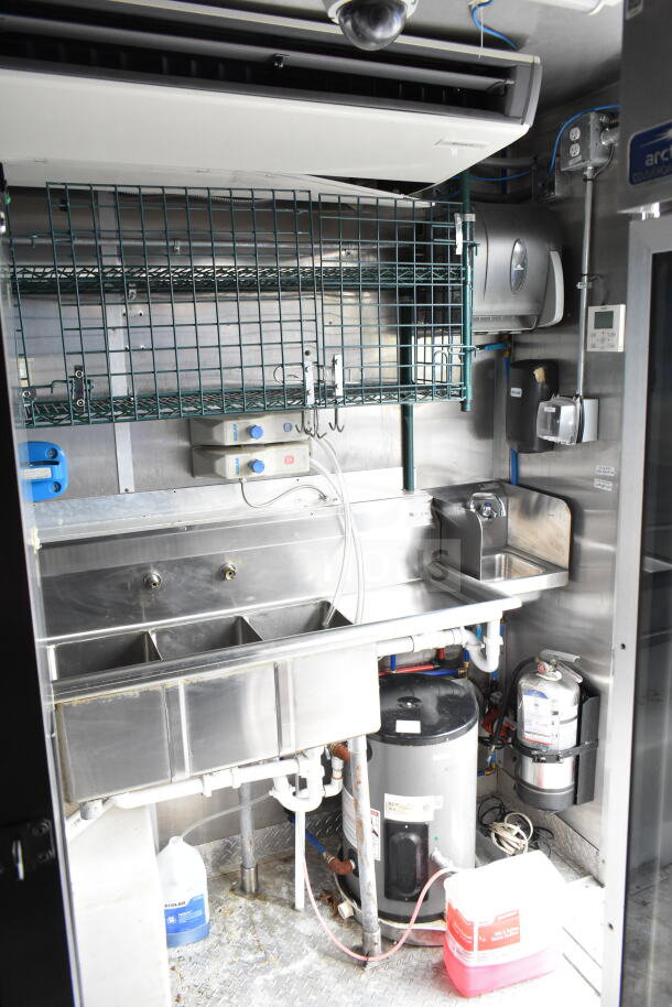 NBRHD Kitchens ghost kitchen food trailer interior featuring dual Pitco gas fryers, CaptiveAire hood, Arctic Air fridge, Daikin mini-split.
