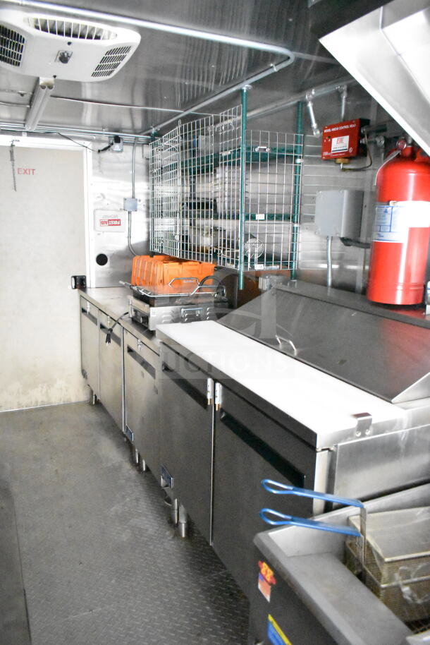 NBRHD Kitchens food trailer interior with dual Pitco gas fryers, CaptiveAire hood, Arctic Air refrigeration, Daikin mini-split.