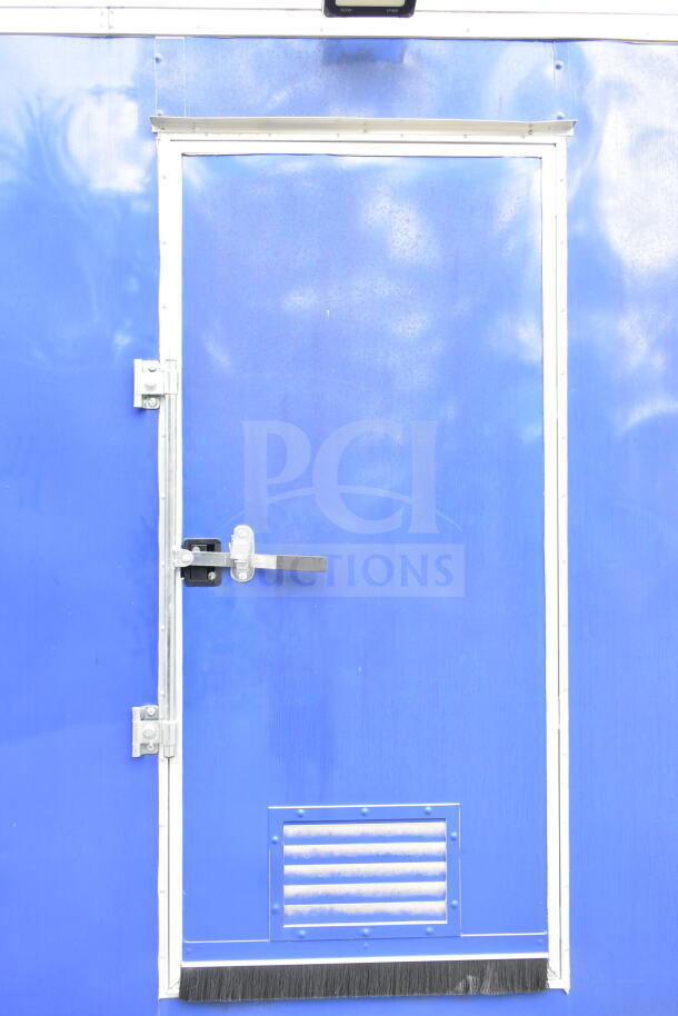 Blue exterior door of 2021 Rock Solid Cargo 28ft food trailer, showing lock and vent detail.