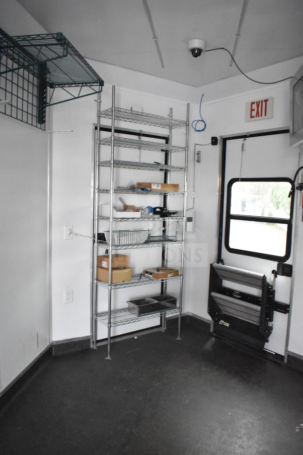 2020 Southern Dimensions Group 20ft mobile commissary trailer interior, featuring wire shelving and exit door in excellent condition.
