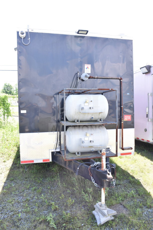 2021 Cruising Kitchens 8.5'x24' food trailer, black exterior, propane tanks visible, VIN 7PLBC2429MM000193.