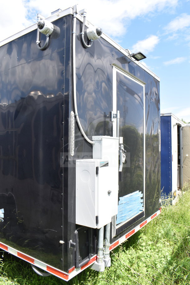2021 Cruising Kitchens 8.5'x24' food trailer, black exterior, equipped with security cameras, excellent condition.