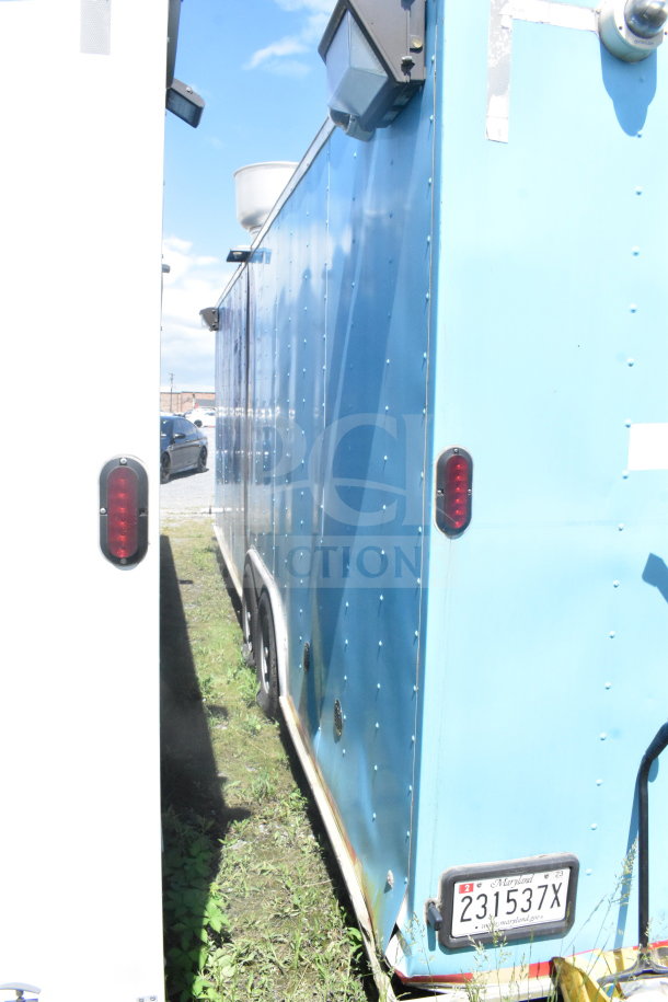2020 Diamond Cargo 8.5'x24' food trailer in blue. Visible wear, with Maryland license plate. Ventilation unit on top.