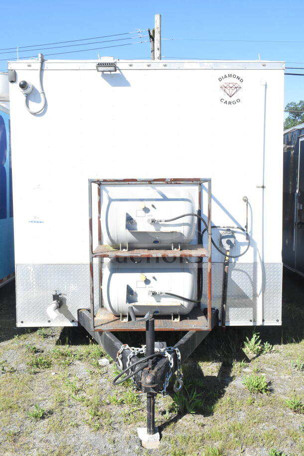 2021 Diamond Cargo 8.5'x24' food trailer in white, featuring dual propane tanks and hitch; logo visible, in good condition.