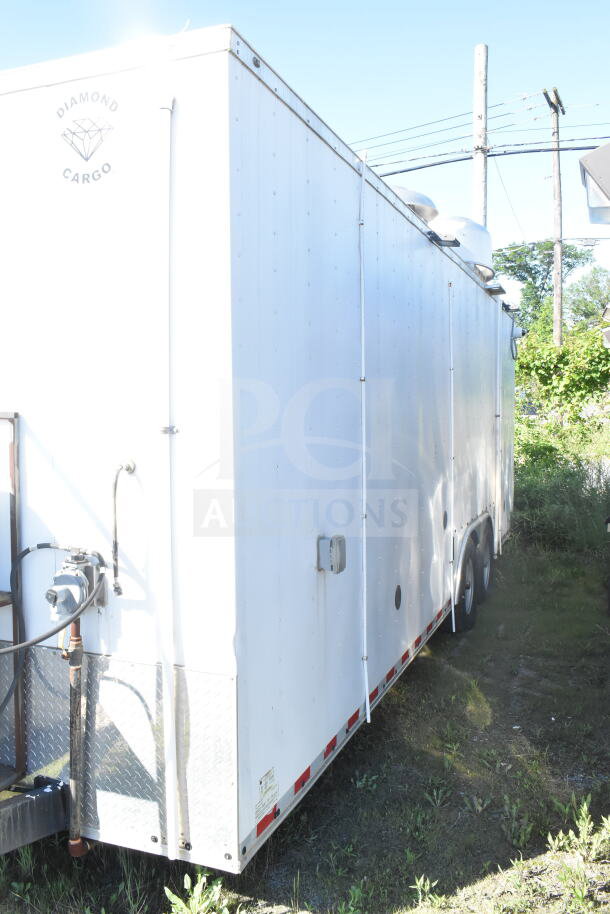 2021 Diamond Cargo 8.5'x24' food trailer, good condition, white exterior, VIN: 53NBE242XM1089713, visible logo.