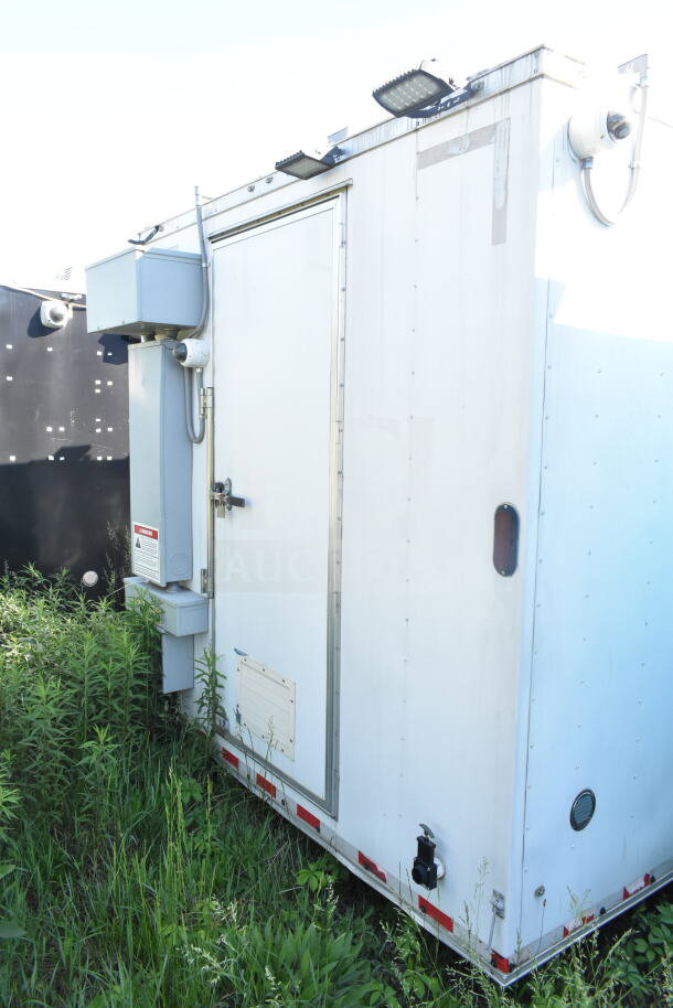 2021 Diamond Cargo 8.5'x24' food trailer, white exterior, utility connections, and secured door. VIN: 53NBE242XM1089713.