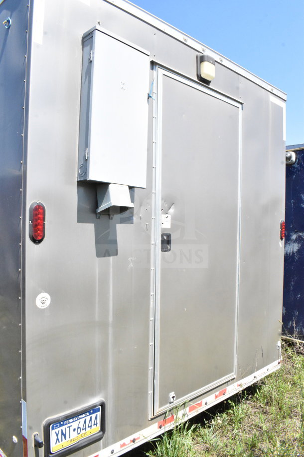 2021 Diamond Cargo 8.5'x24' food trailer, showing side door, electrical box, and Pennsylvania plate. Minor dents visible.