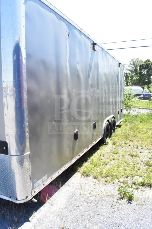 2021 Diamond Cargo 8.5'x24' food trailer, silver exterior, dual axle, visible minor dents, VIN: 53NBE2424M1089867.
